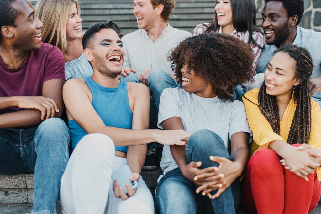 multi-cultural group of young adults laughing and having fun outdoor in the city