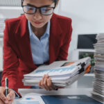 Young woman reviewing contracts