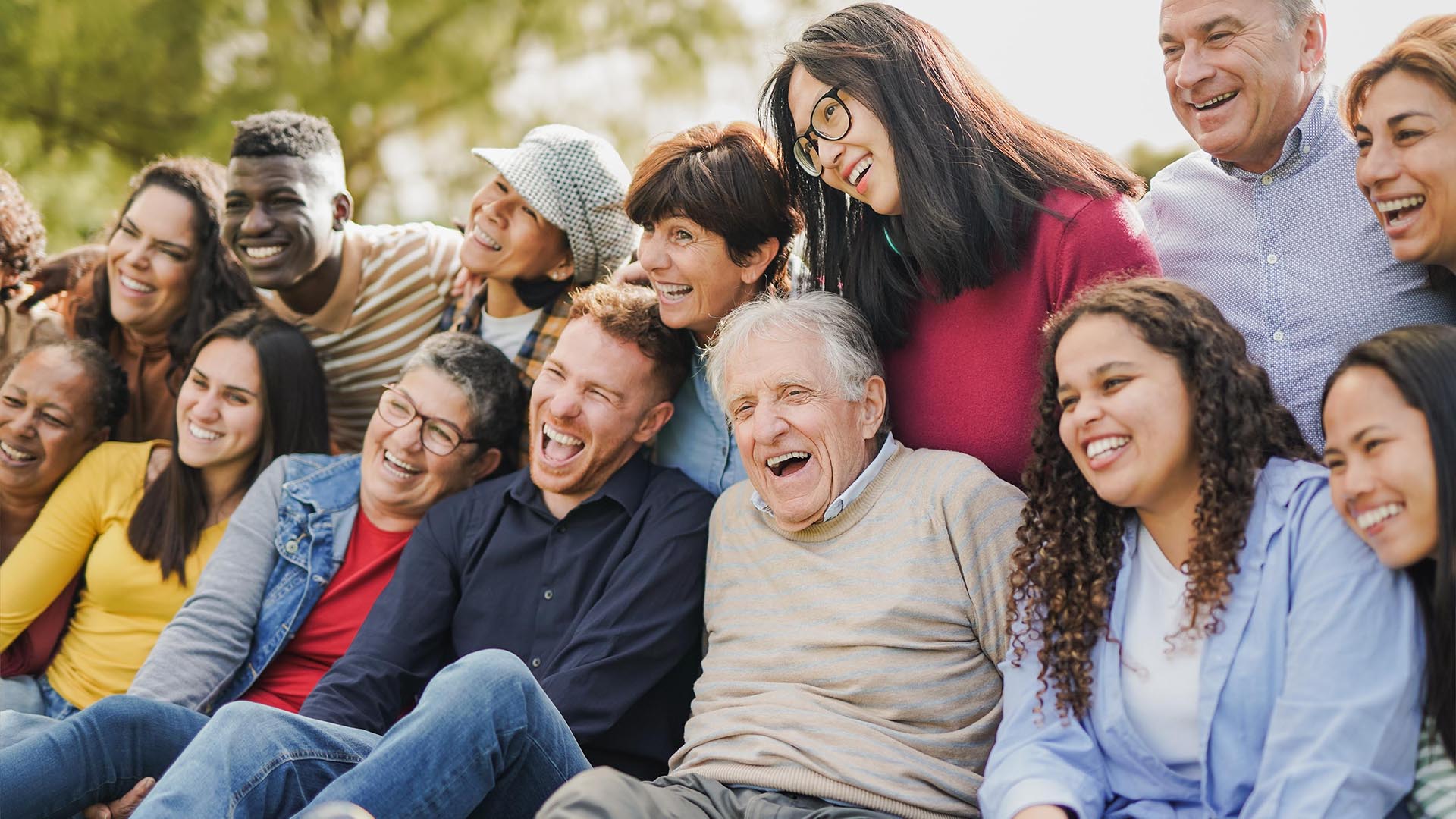 Diverse group of people sitting outdoors having fun
