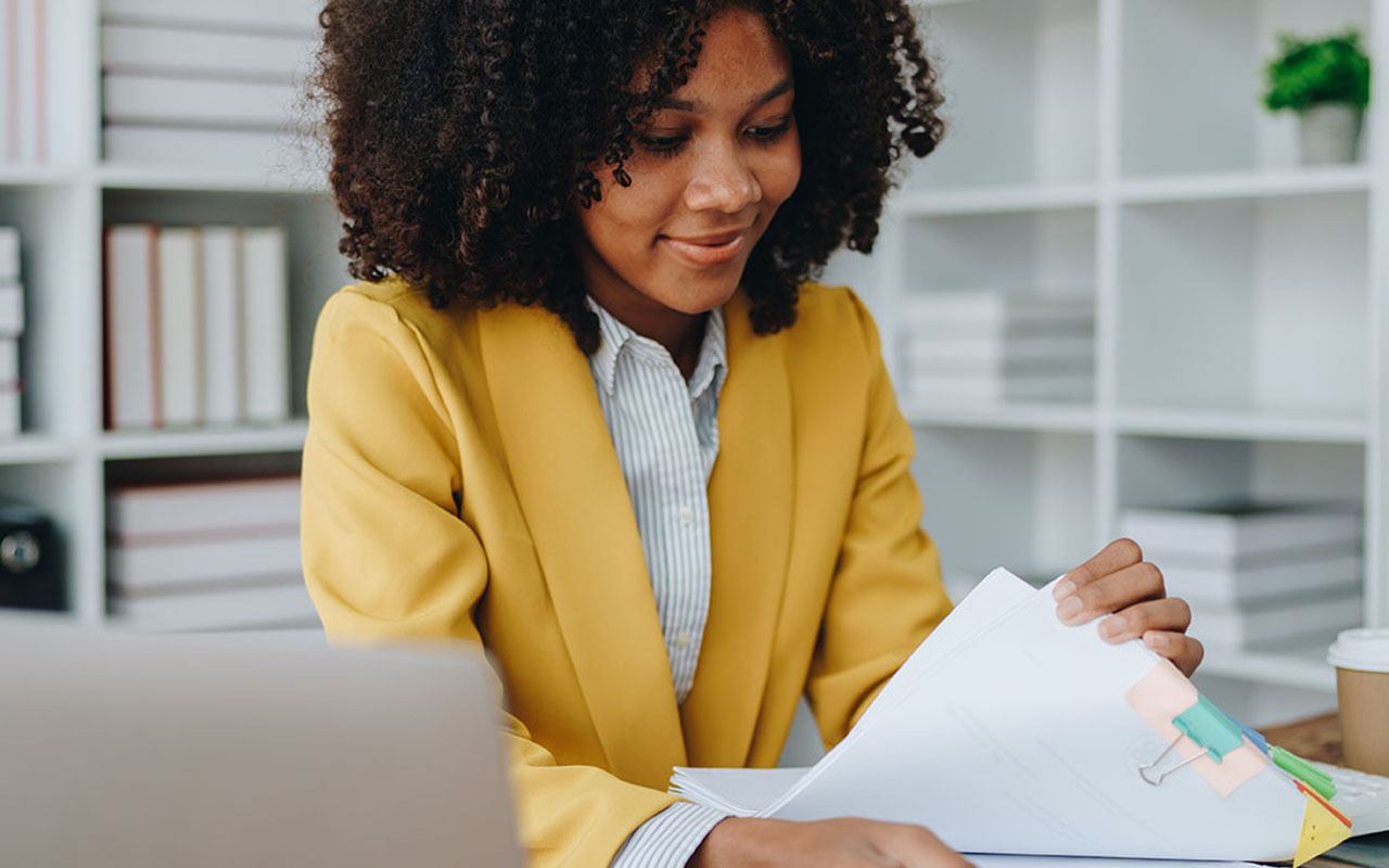 African American Woman reviewing contracts